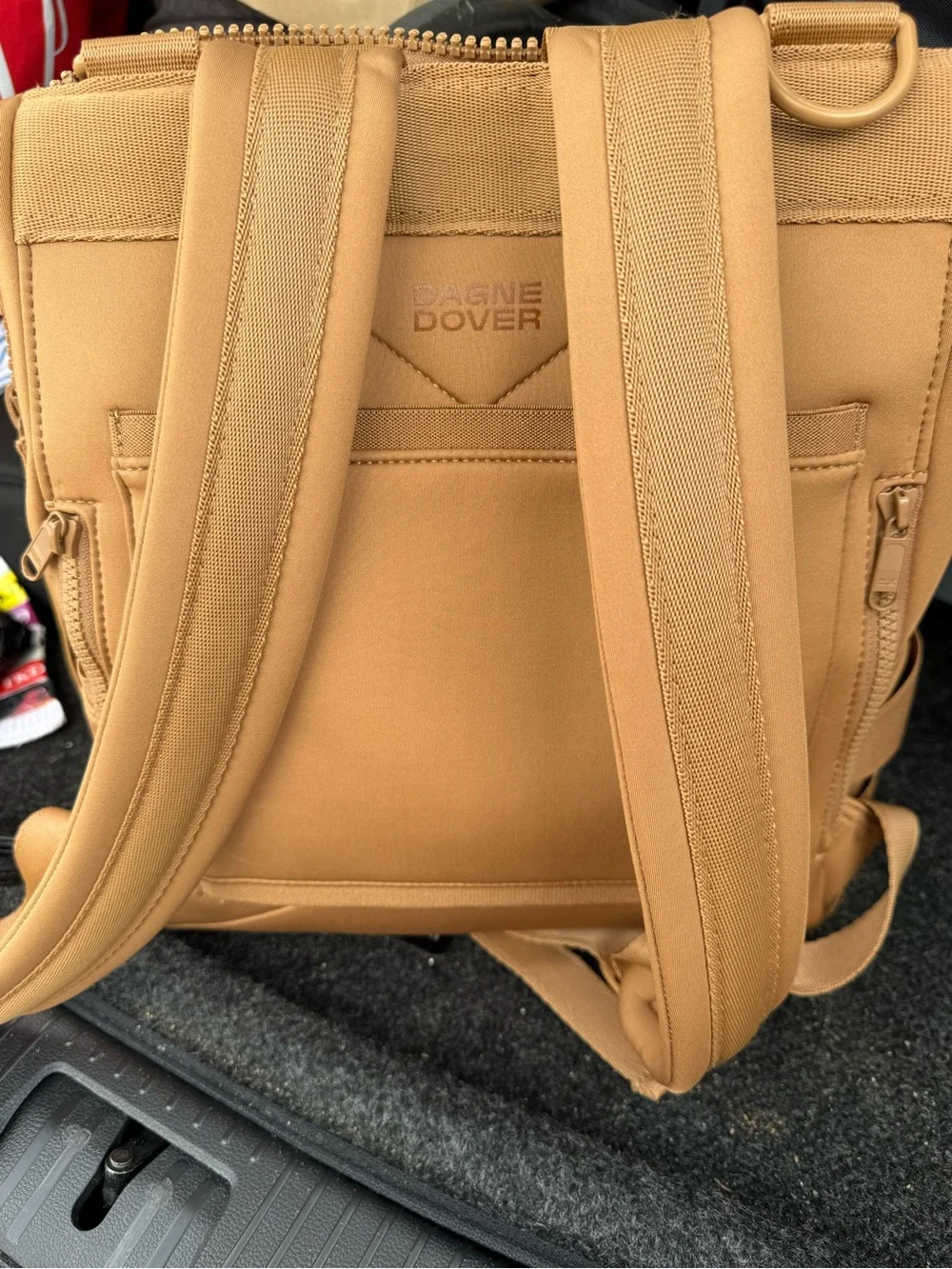 This is a Dagne Dover Dakota Neoprene Backpack in the color Camel.